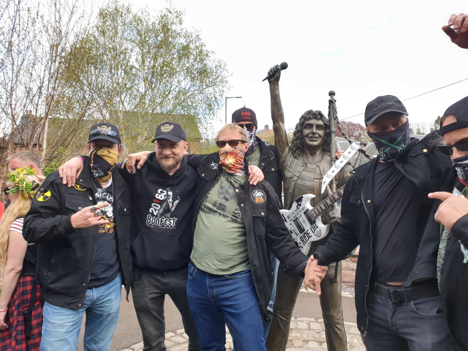Fans posing at the Bon Scott statue
