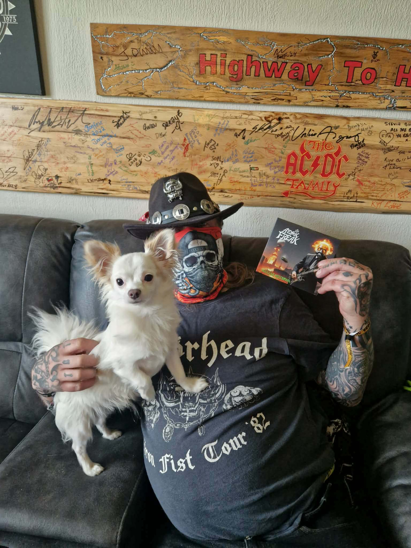 Freak Family member in a mask with a small dog and CD