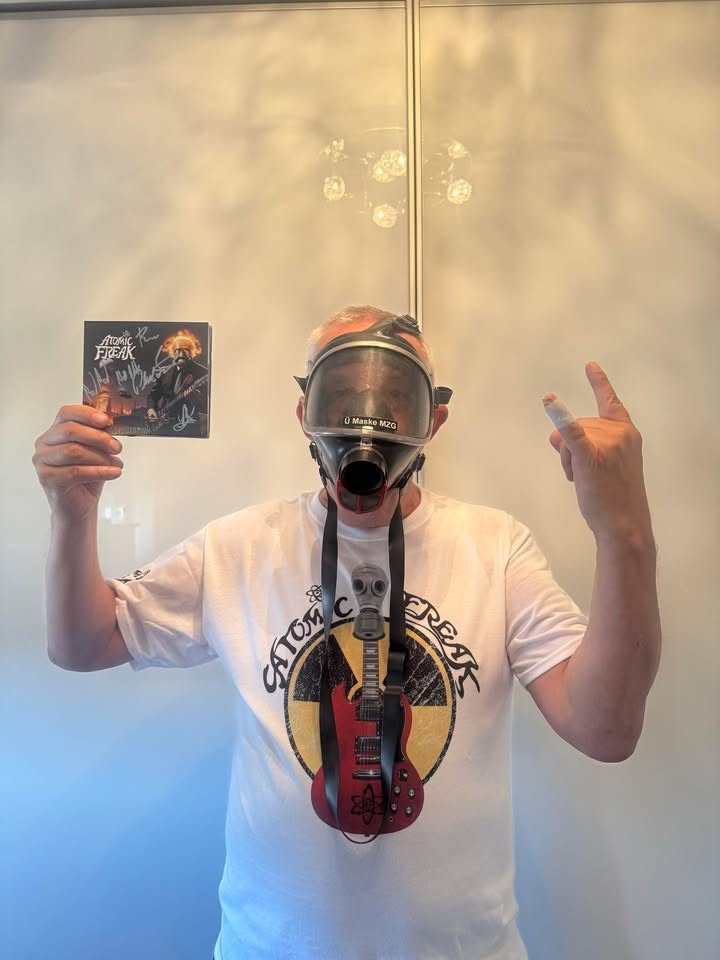 Freak Family member in a gas mask holding a signed CD