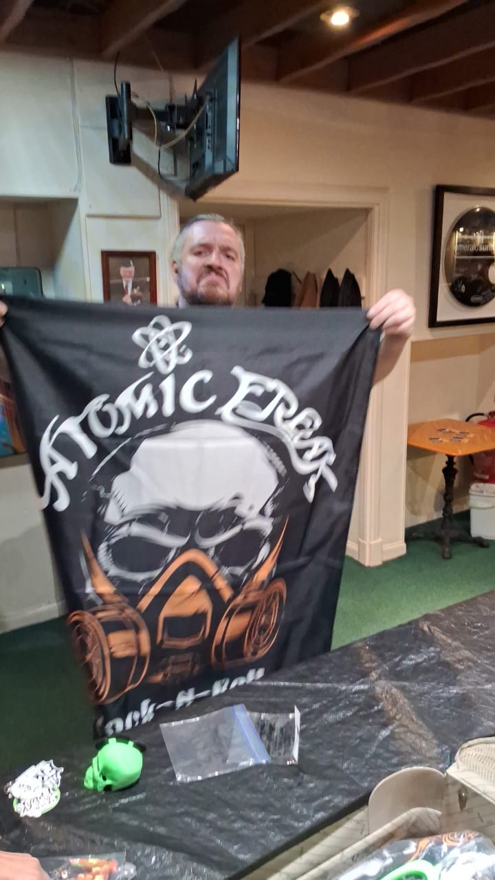 Fan holding an ATOMIC FREAK flag