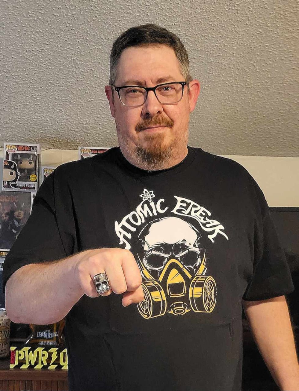 Freak Family member in a gas mask tee showing a skull ring