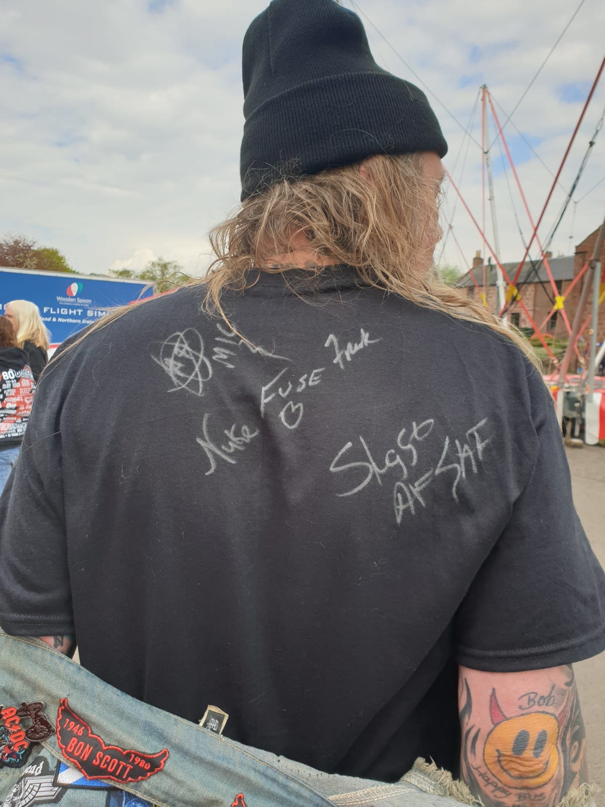 Fan wearing a band-signed shirt
