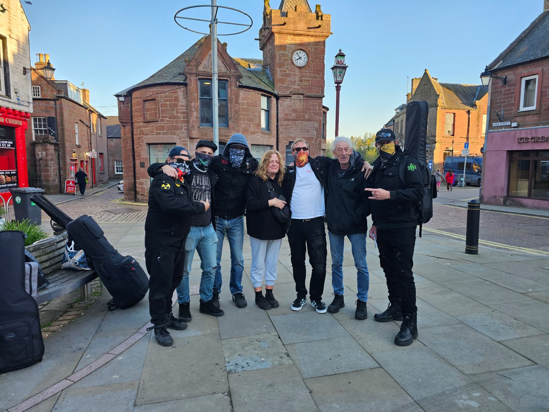 The band with friends in a historic town square
