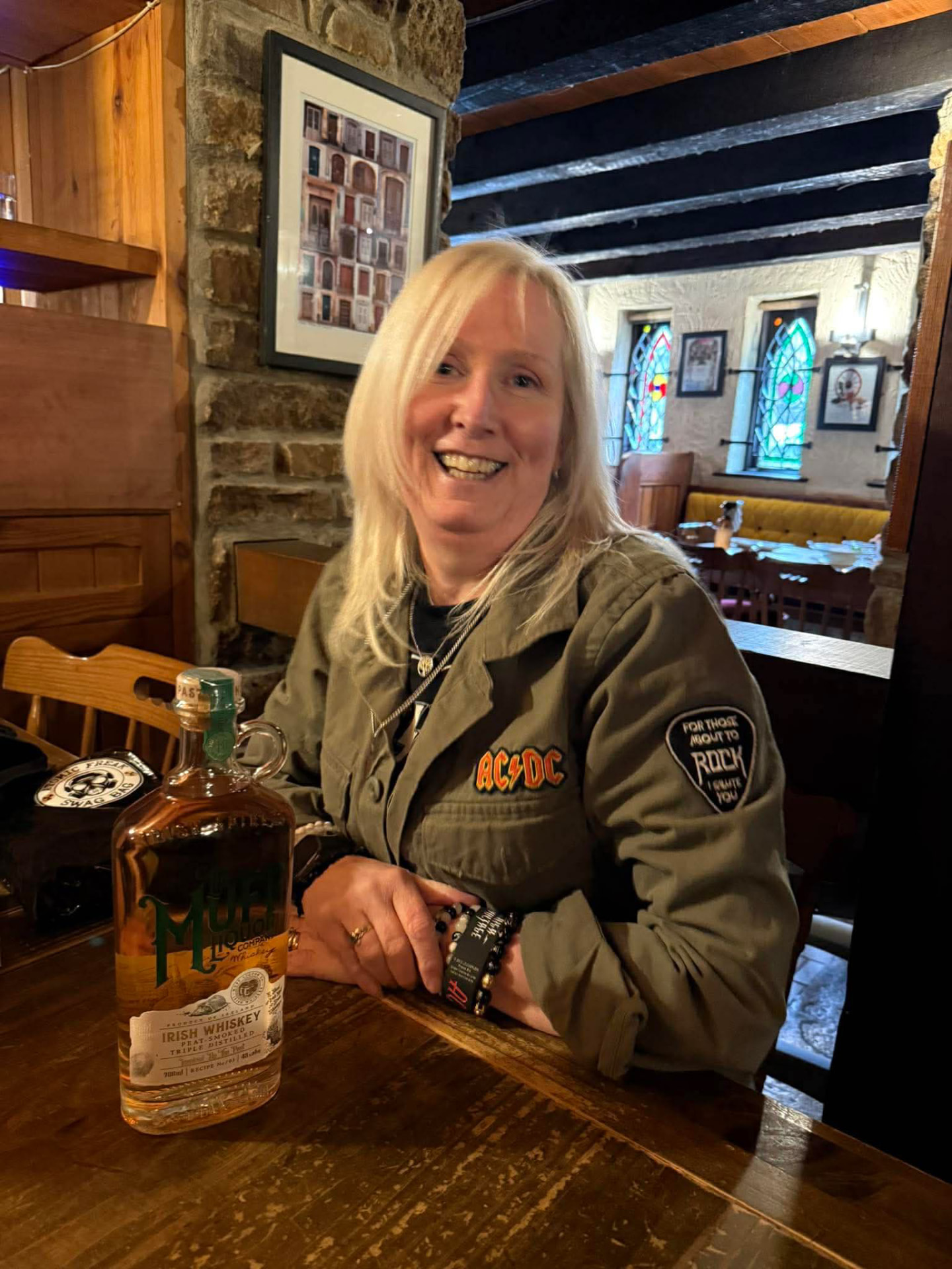 Fan in an AC/DC jacket at a pub table